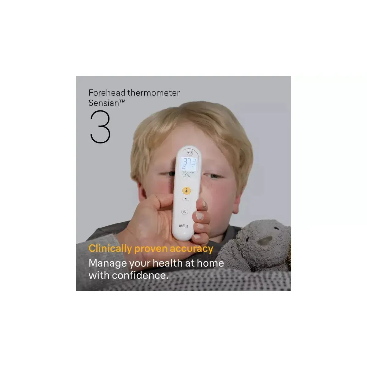 White Braun Sensian 3 non-contact forehead thermometer held to a child's forehead showing a digital temperature reading.