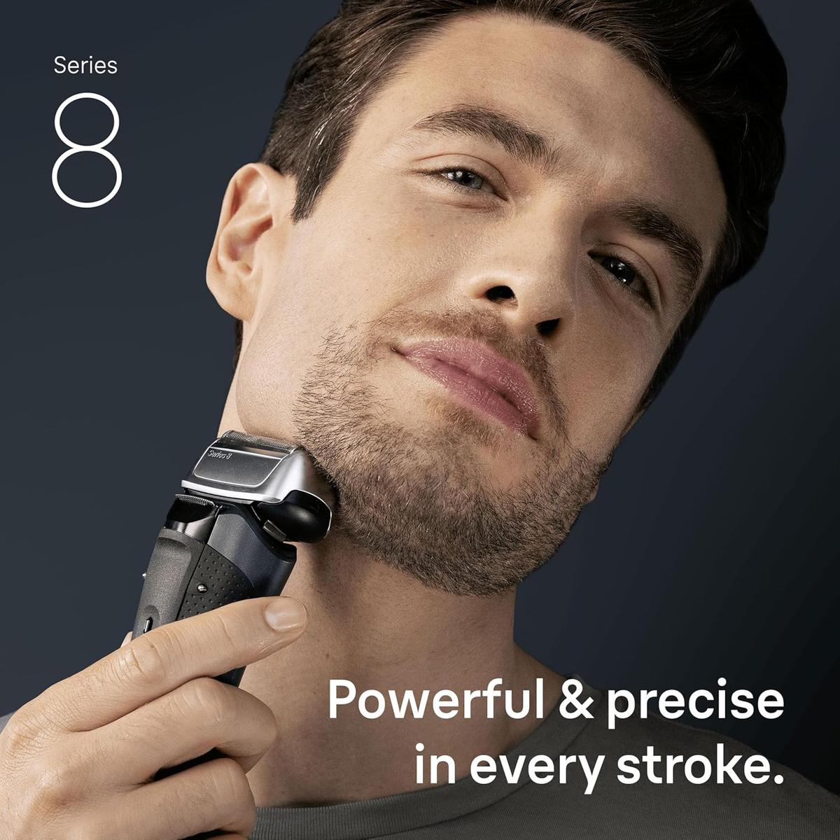 Man using a grey Braun Series 8 electric shaver with a 4+1 precision head on his jawline against a dark background.