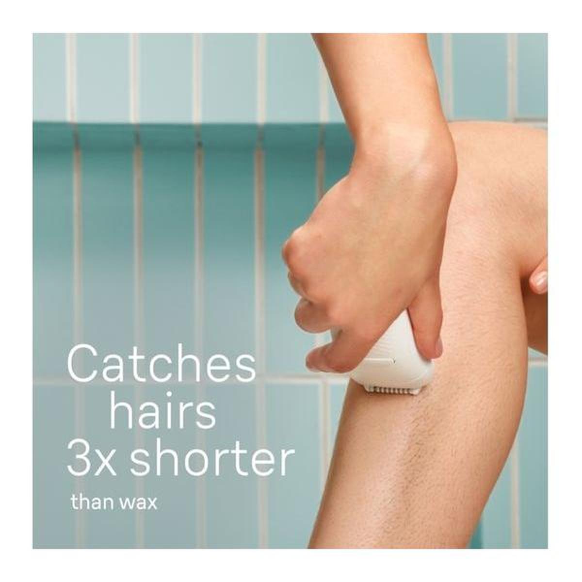 White Braun Silk-épil 5 cordless epilator being used on a leg against a blue tiled background.