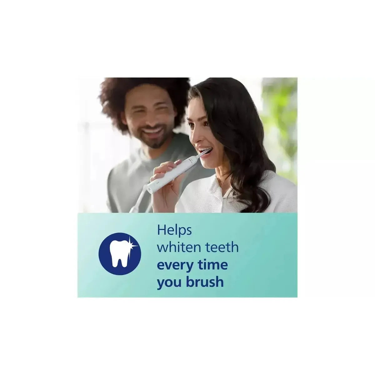 Woman using a white Philips Sonicare 4100 electric toothbrush with a man smiling in the background.