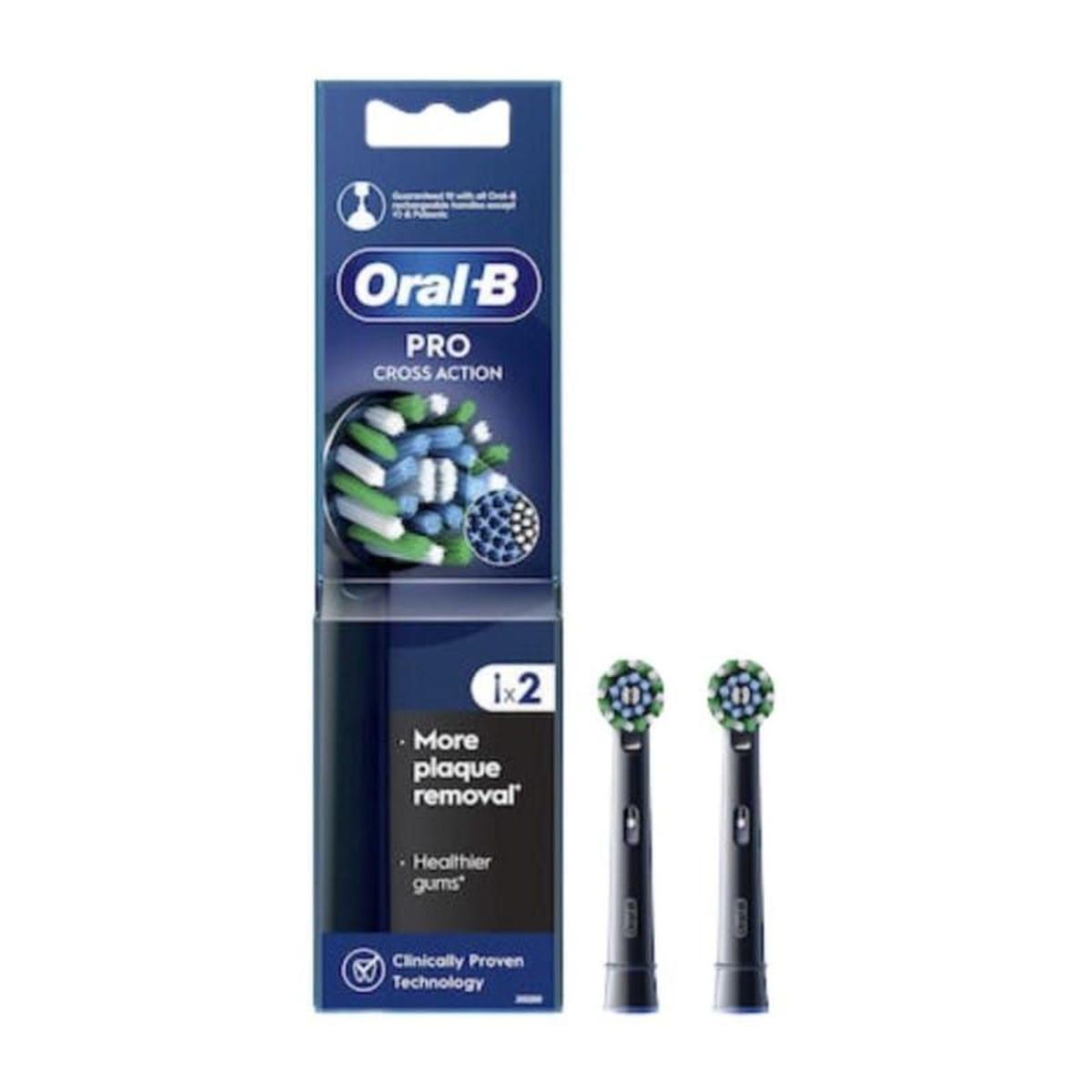 Two black Oral-B Pro Cross Action replacement toothbrush heads with angled X-shaped bristles in retail packaging.