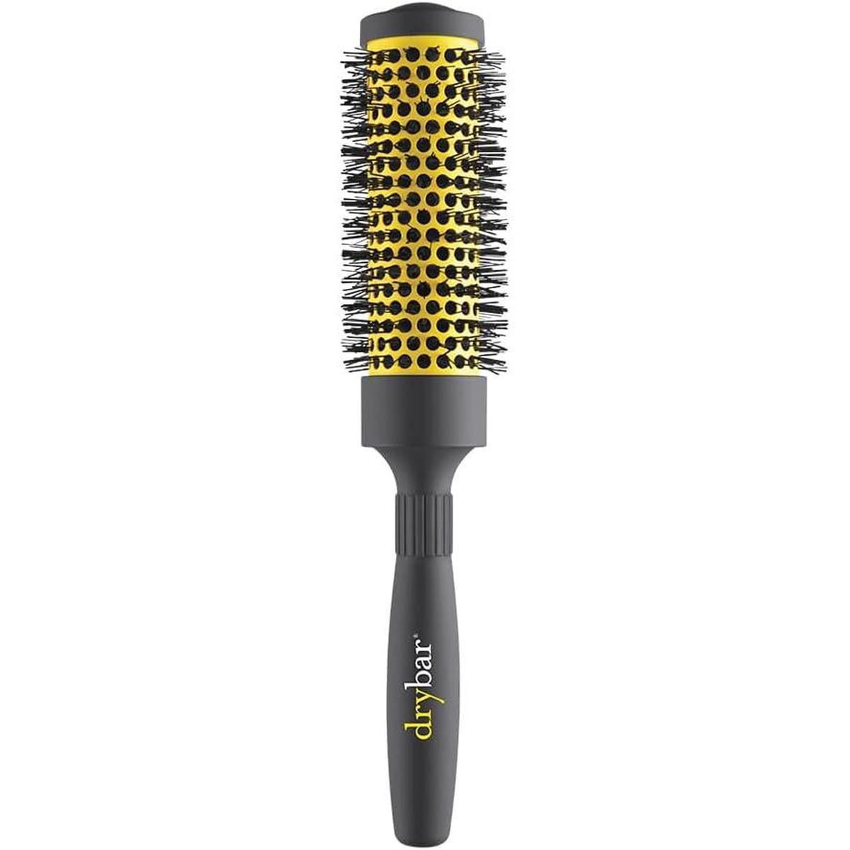 Drybar 1.75-inch vented ceramic round brush with a yellow barrel, black bristles, and a grey ergonomic handle.