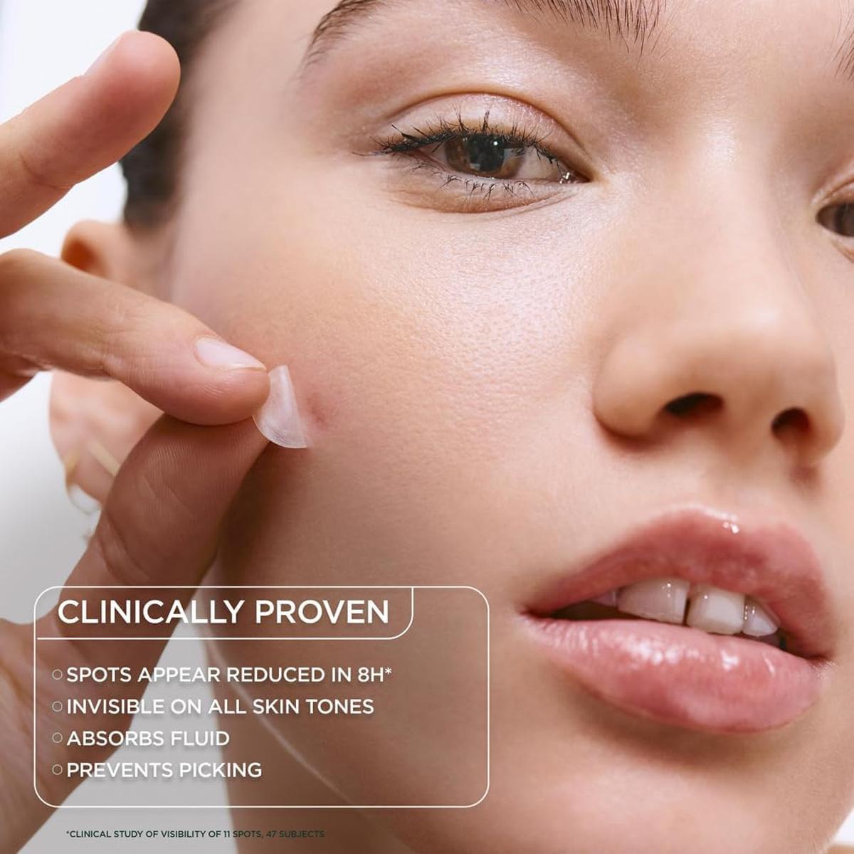 Person applying a thin, clear hydrocolloid blemish patch to a spot on their cheek for invisible, 8-hour spot treatment.