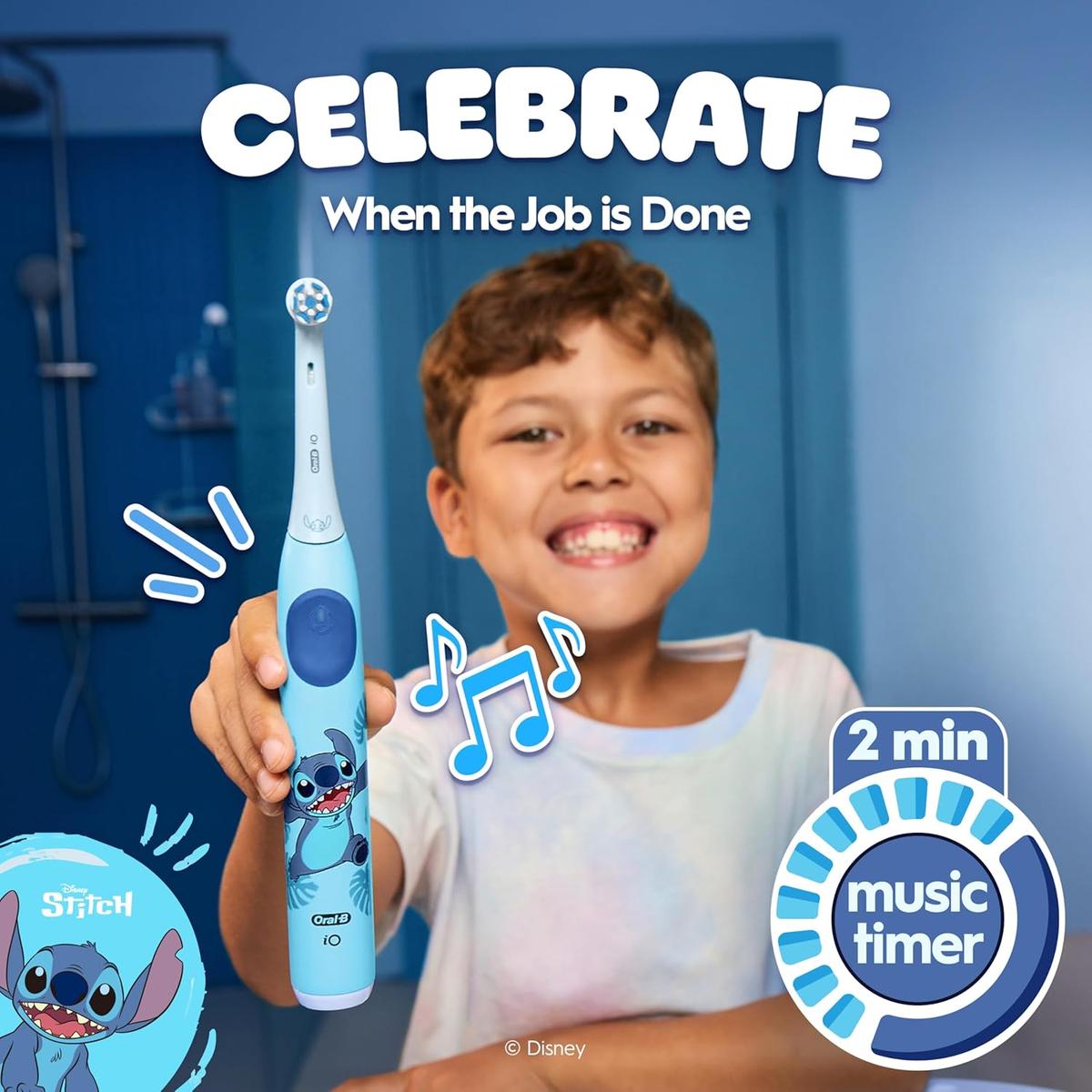 A smiling child holds a blue Oral-B iO Kids electric toothbrush featuring a Disney Stitch design with a 2-minute music timer.