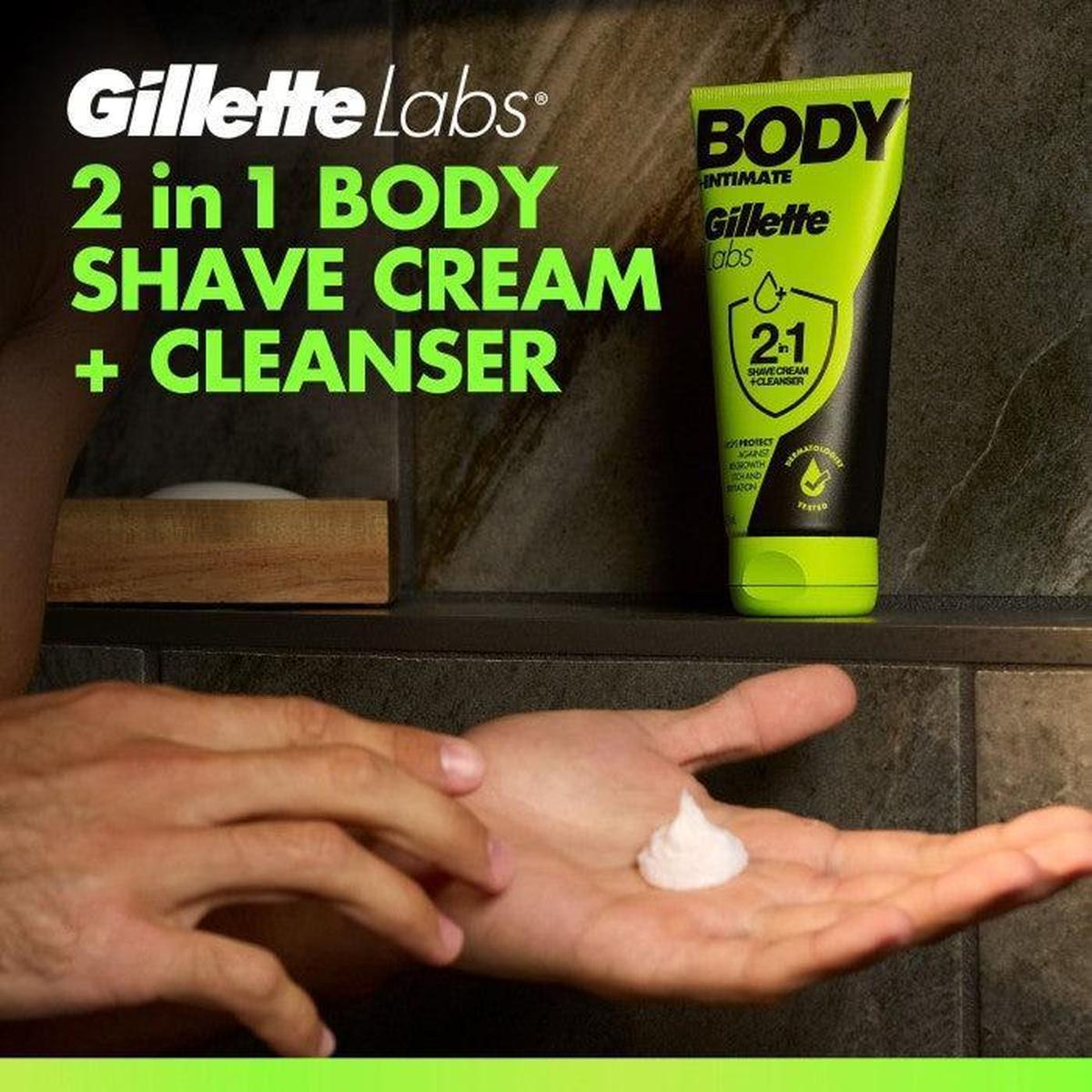 GilletteLabs 2-in-1 body shave cream and cleanser in a black and neon green tube with a dollop of white cream in a hand.