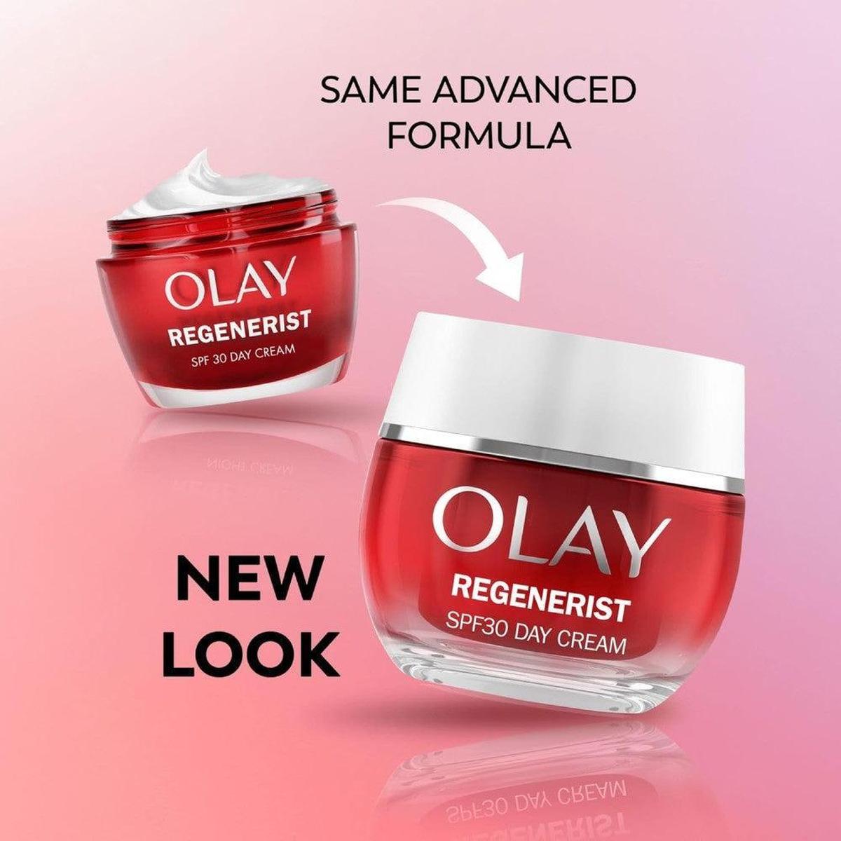 Olay Regenerist SPF30 day cream in a red glass jar with a new white lid design against a soft pink background.