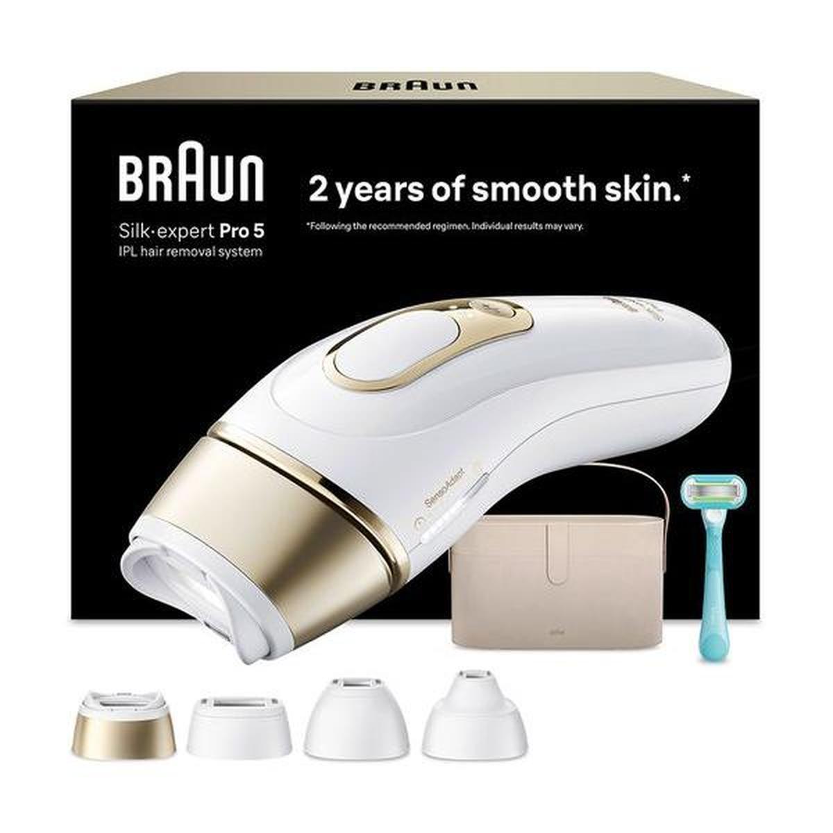 White and gold Braun Silk-expert Pro 5 IPL device with four attachments, a storage case, and a razor in front of its box.