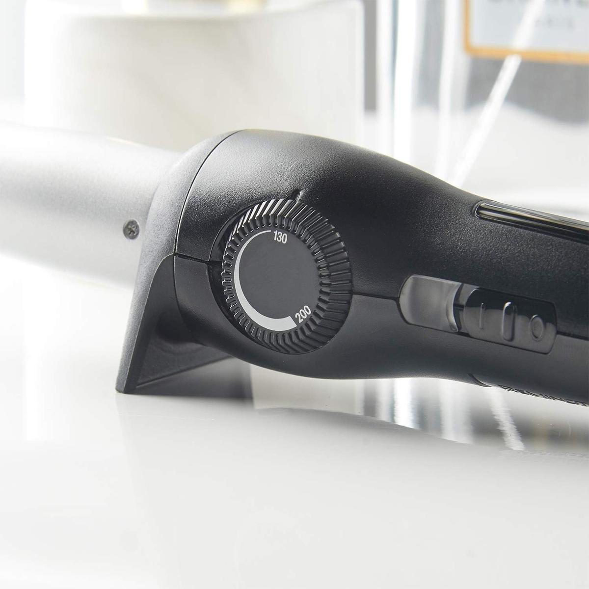 Remington curling wand in black with a silver barrel and an adjustable temperature dial ranging from 130 to 200 degrees.