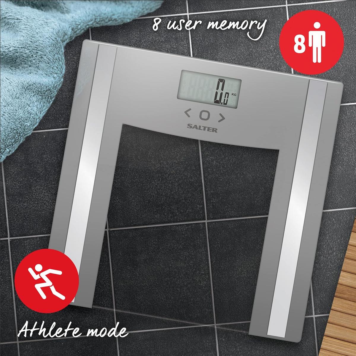 Silver Salter glass analyser bathroom scale with digital display, 8-user memory, and athlete mode on a tiled floor.