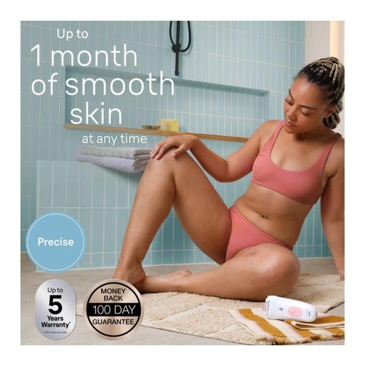 Braun Silk-épil 5 white and flamingo wet and dry cordless epilator with massage roller cap on a bathroom floor.