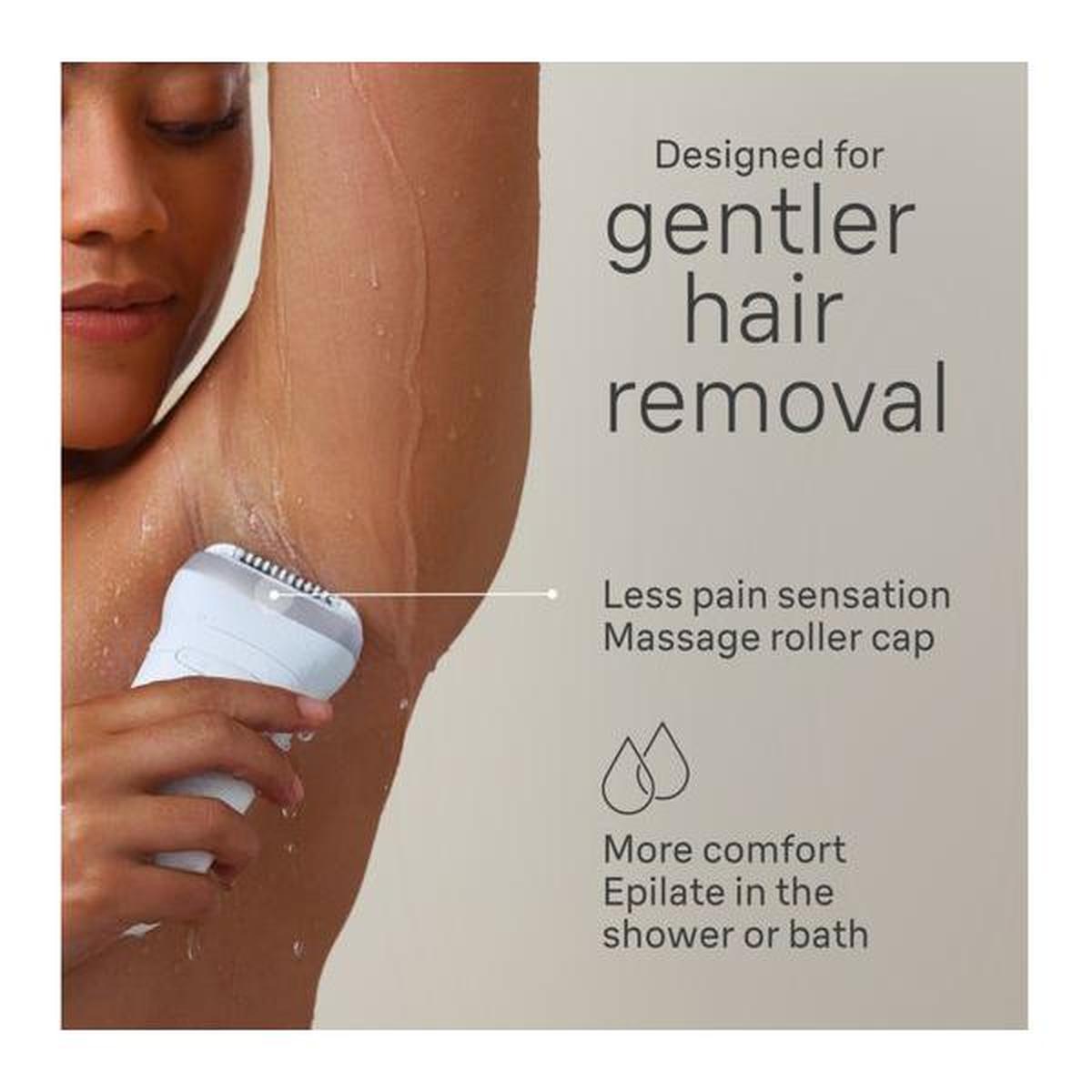 Grey Braun Silk-épil 7 wet and dry epilator with a massage roller cap being used for gentle underarm hair removal.