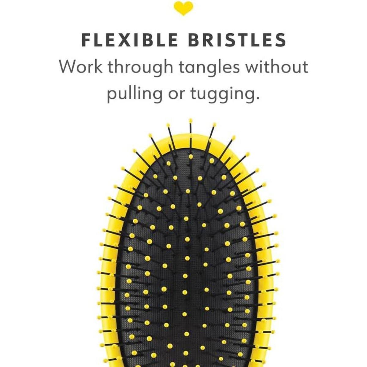Drybar Super Lemon Drop detangling brush with flexible black bristles and a bright yellow oval frame.