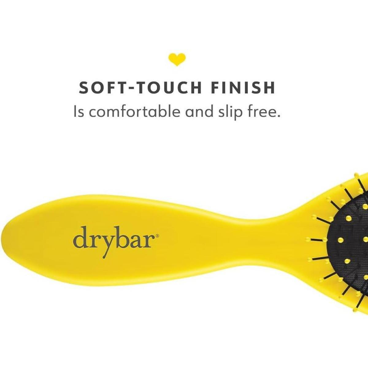 Yellow Drybar Super Lemon Drop detangling brush with a soft-touch, slip-free handle and flexible black bristles.