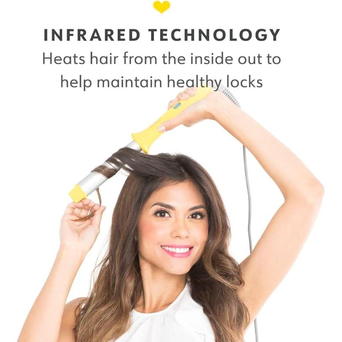 Woman using a yellow Drybar Wrap Party curling wand to style her long brown hair with infrared technology.