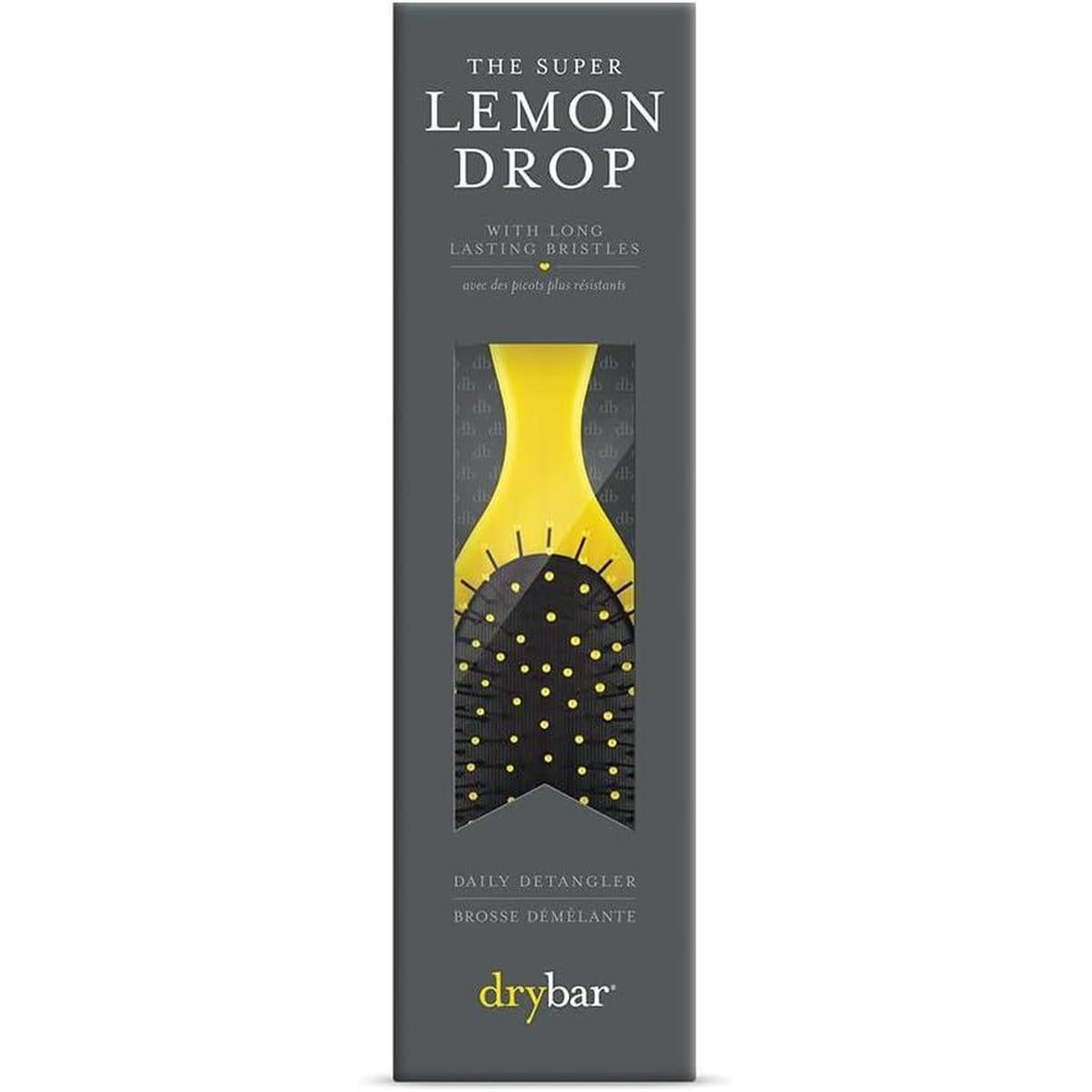 Drybar Super Lemon Drop detangling brush in yellow with black bristles, packaged in a vertical grey retail box.