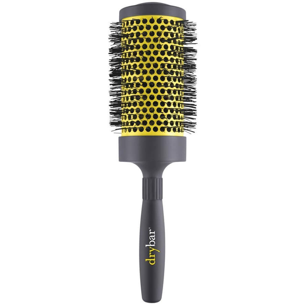 Drybar Double Pint 7cm round ceramic hair brush with a yellow vented barrel and grey soft-touch handle.