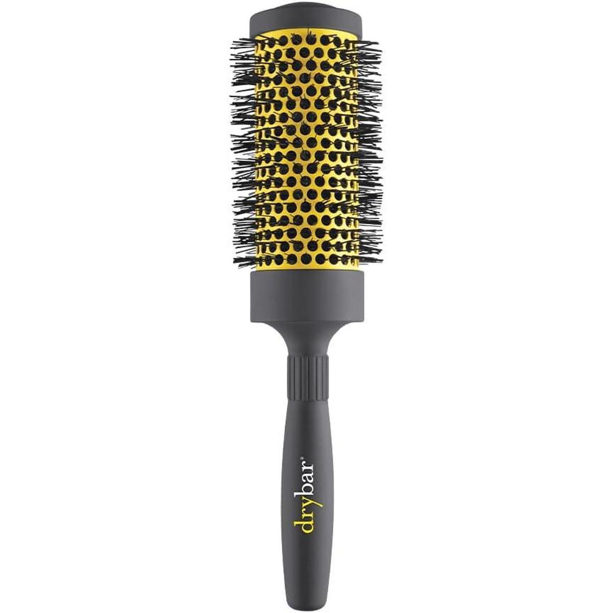 Drybar The Pint ceramic round hair brush with a yellow vented barrel and a grey ergonomic soft-touch handle.