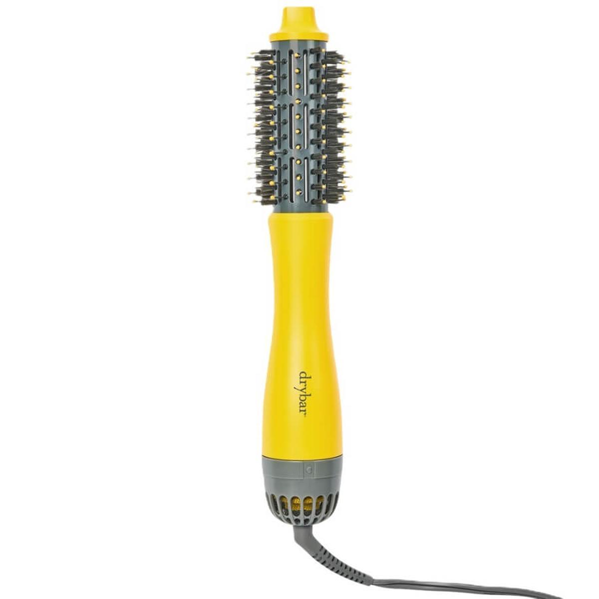 Drybar Half Shot 3.8cm yellow and grey round blow-dryer brush with tufted bristles and ergonomic handle.