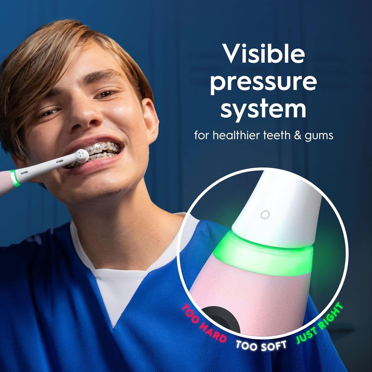 Person brushing teeth with a blush pink Oral-B iO5 electric toothbrush featuring a green pressure sensor light.