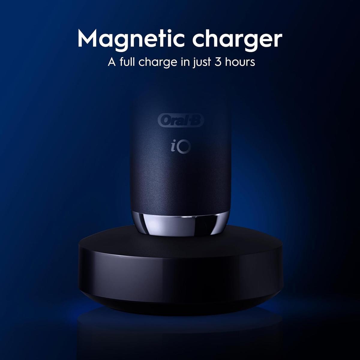 Black Onyx Oral-B iO9 electric toothbrush resting on a sleek, round magnetic charging base against a dark blue background.